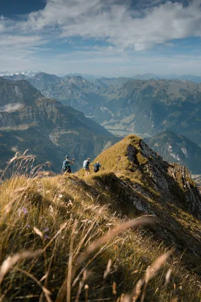 A mountain landscape in summer with a view of other mountains in the background.